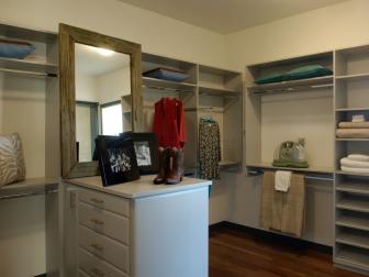 White Walk-In Closet With Center Island and Barn-wood Mirror