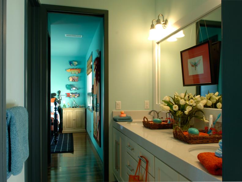 White Shared Bathroom With Orange and Blue Decor