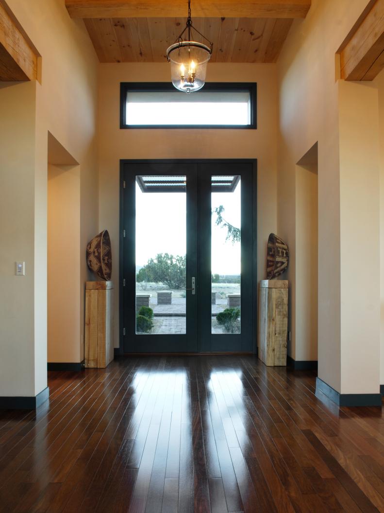 Entry Hall With Wood Ceiling, Black Front Door and Hanging Lantern 