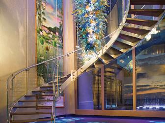 Foyer With Sweeping Glass Staircase, Water Floors and Glass Sculpture