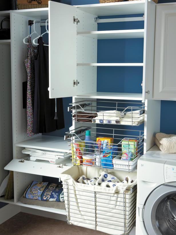 Blue Laundry Room With White Cabinetry and Wire Baskets