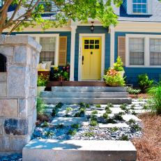 Blue Cape-Cod-Style Home With Yellow Front Door