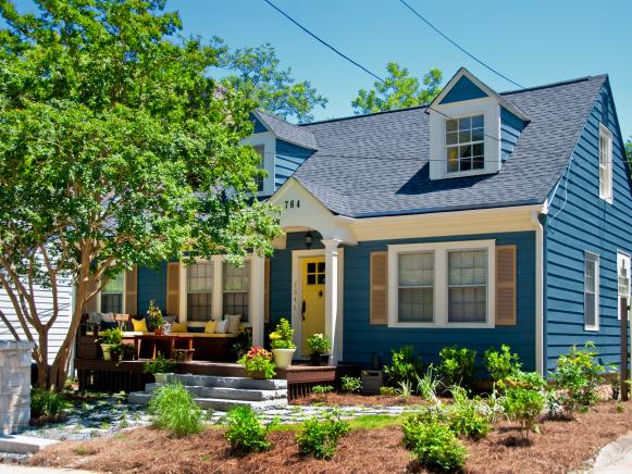 Blue Cape Cod House With Yellow Front Door