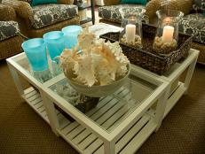 Beach-themed lounge area with candles and seashells.