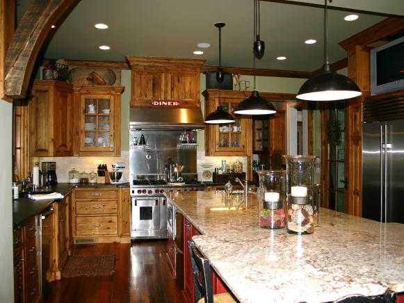 Kitchen With Reclaimed Wood Floor, Wood Cabinets and Black Pendants