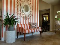 Bold stripes and beach cabana style lend a casual air of elegance to this statement-making space.