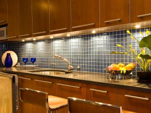 Kitchen With Chrome Accents and Lit Tile Backsplash