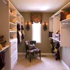 Large Walk-In Closet With White Cabinetry