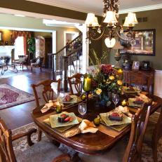 Traditional Deep-Green Dining Room With White Wainscotting and Molding