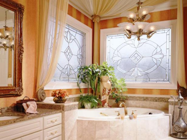 Traditional bathroom with a marble tub surround and gauze canopy.
