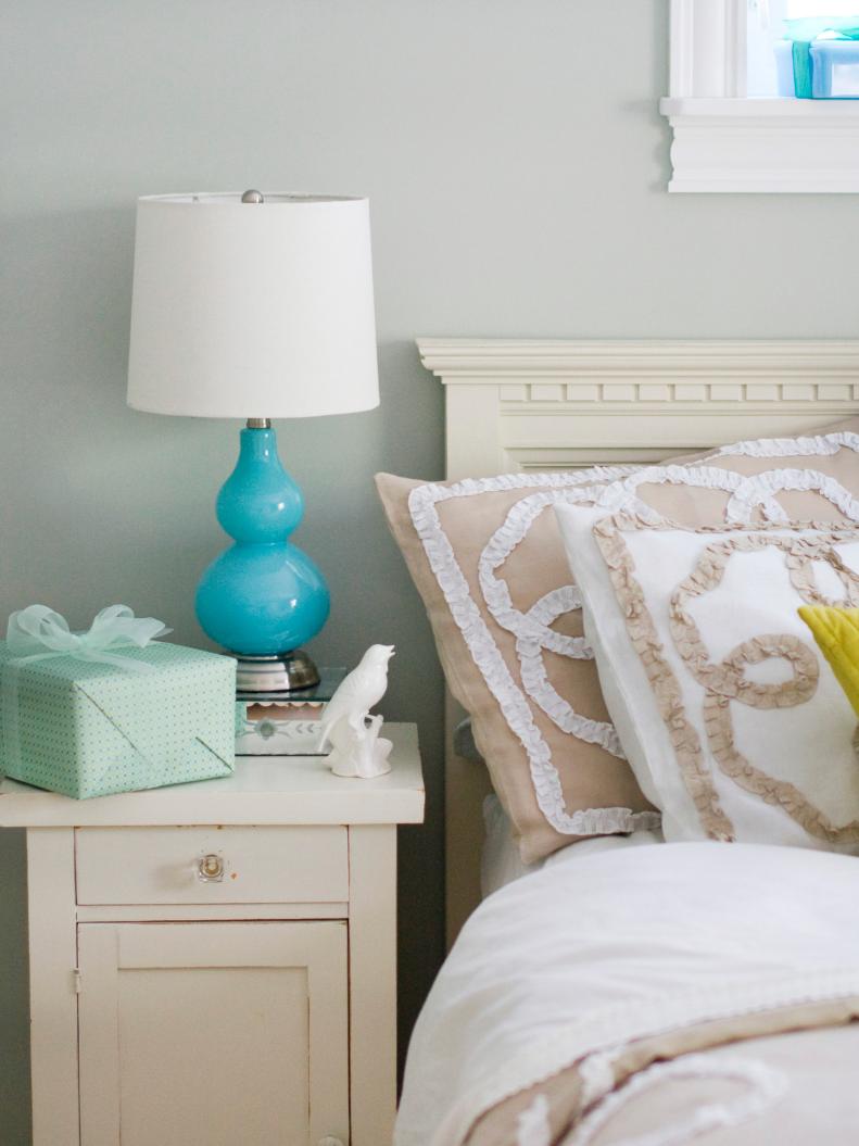 Bedroom With Shabby Chic Nightstand and Ruffled Pillows 
