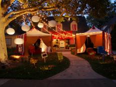 Designer Michelle Buckley shares her ideas for creating an unusual experience this Halloween: Turn your front yard into a creepy sideshow spectacle using pop-up tents to mimic the feel of a travelling carnival.
