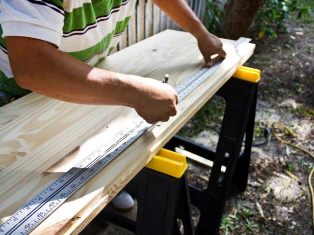 Man measuring wood. 