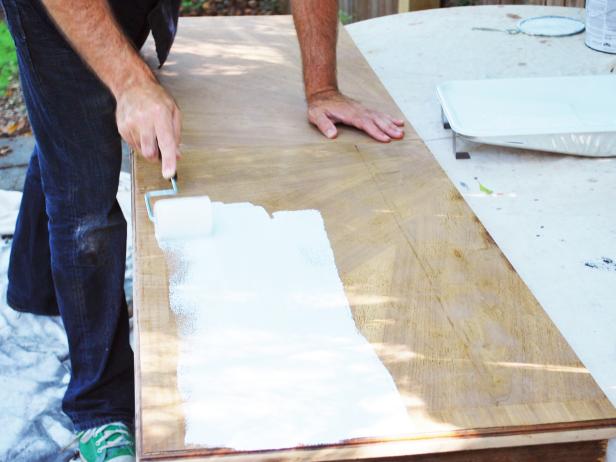 Pour primer into paint pan liner, then use a paint roller to apply a single coat of primer to piece. Paint any remaining areas with one-inch-angled paint brush. Let dry.