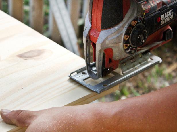Wood being cut with a handheld jigsaw. 