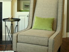 Green Pillow on Transitional Neutral Chair With Nailhead Trim