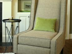 Green Pillow on Transitional Neutral Chair With Nailhead Trim