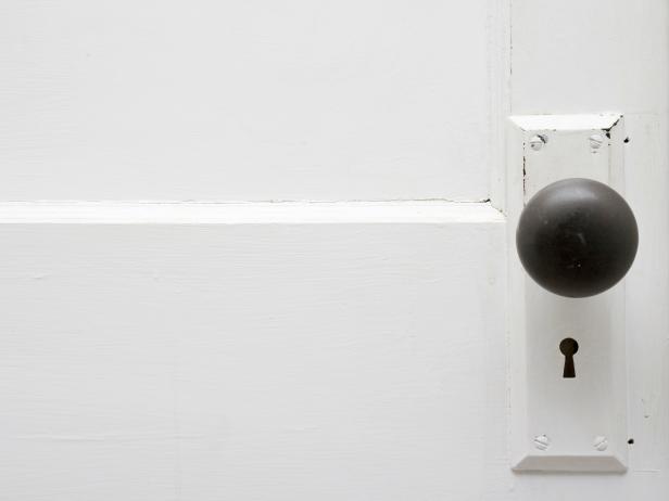 Antique Doorknob on a White Door