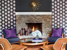 Retro Room With Graphic Wallpaper & Starburst Clock Above Fireplace