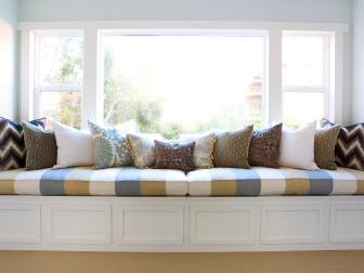 Bedroom Window Seat with striped cushions and patterned pillows