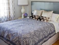 Bedroom Featuring Bed With Patterned Duvet Cover and Chevron Rug
