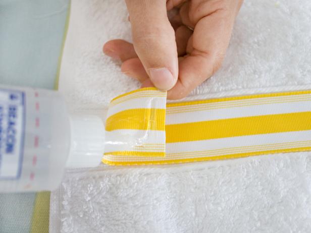 Applying Glue to White and Yellow Striped Ribbon