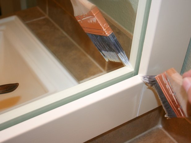 Paintbrush in Corner of White Trim on Mirror