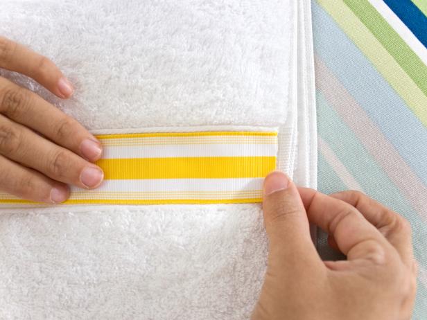 Applying Yellow and White Striped Ribbon on Towel