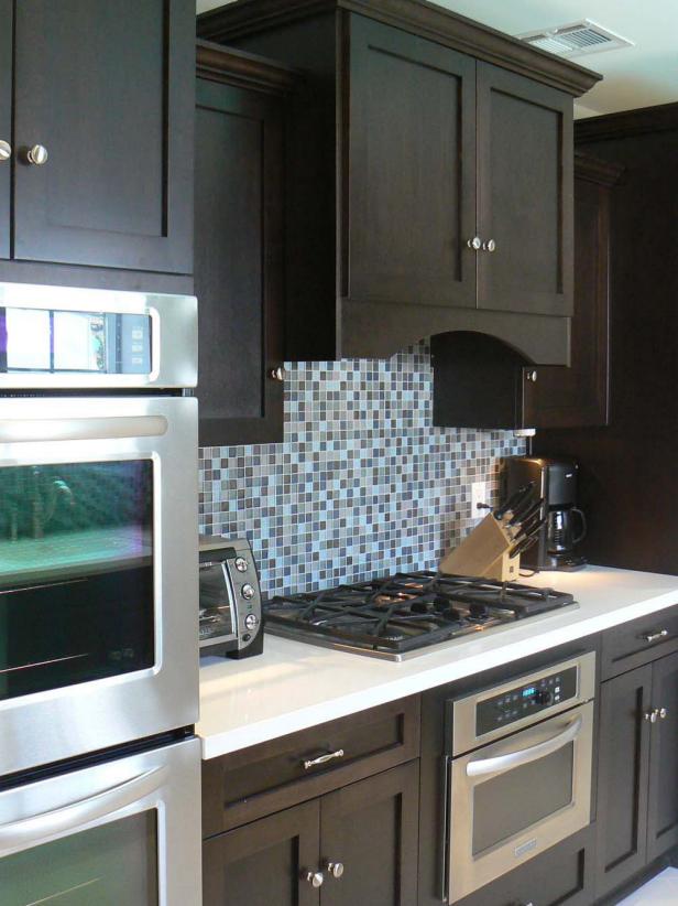 Contemporary Kitchen With Rich Brown Cabinetry and Mosaic Tile Backsplash  HGTV