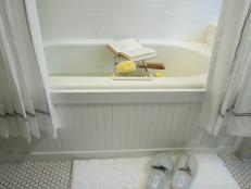 Traditional White Bathroom Tub Surrounded By Beadboard