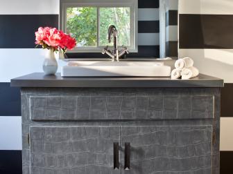 Bathroom With Black and White Striped Walls and Gray Vanity