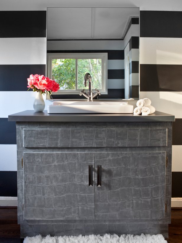 Bathroom With Black and White Striped Walls and Gray Vanity