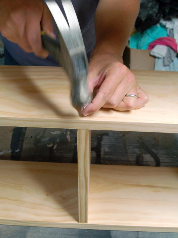 Drive screws through pilot holes until shelf is tight against side. Repeat on opposite side until all four shelf-length pieces are securely fastened to sides. If vertical piece is desired on the top shelf, center a piece of wood and attach with nails. Tip: Use woodworking clamp to hold sides and shelf snugly together.