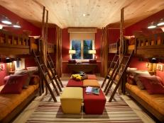 This colorful ski dorm, which accommodates up to eight guests and makes use of a saturated color palette, offers both privacy and entertainment opportunities.
