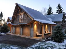 Mountain-lodge style extends to the garage, clad in poplar bark siding. Sturdy timbers, constructed on site, add structural support as well as aesthetic value.