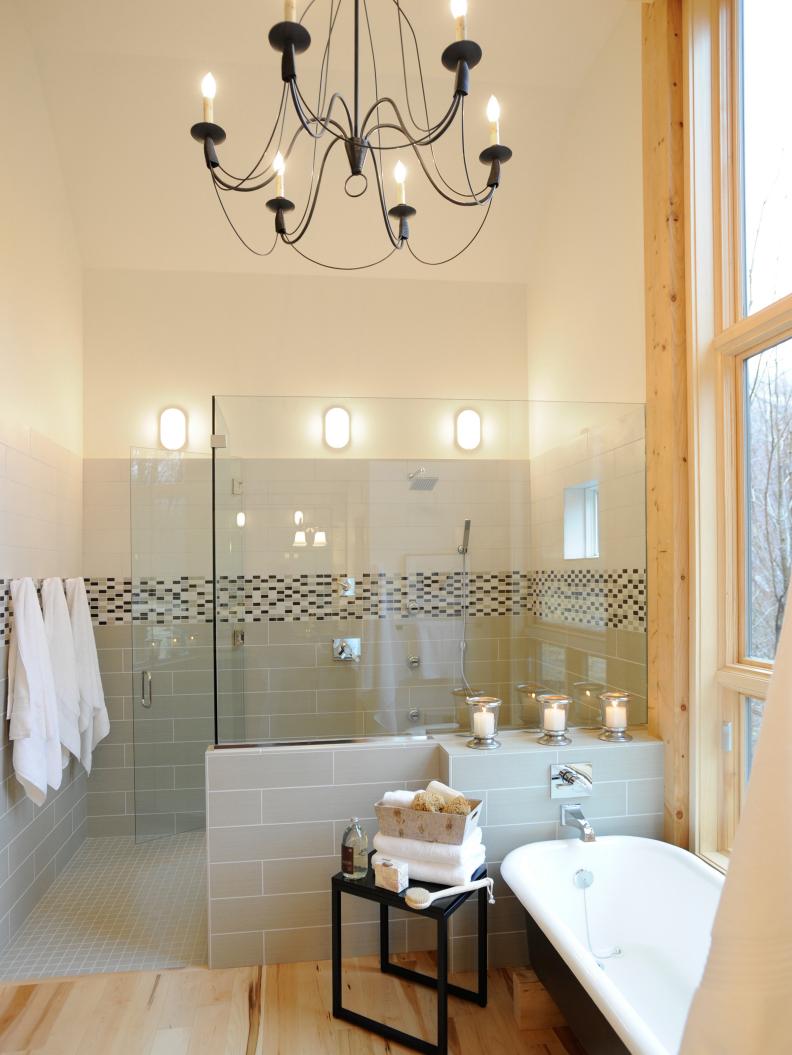 White Bathroom With Light Wood Floors and European-Style Chandelier