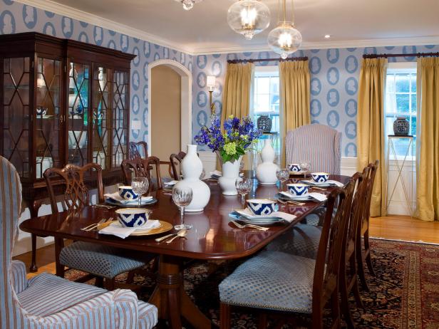 Blue Wallpapered Dining Room With Gold Drapery And Wood