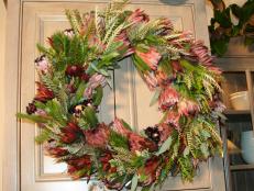 Evergreen Wreath With Pink and Red Flowers