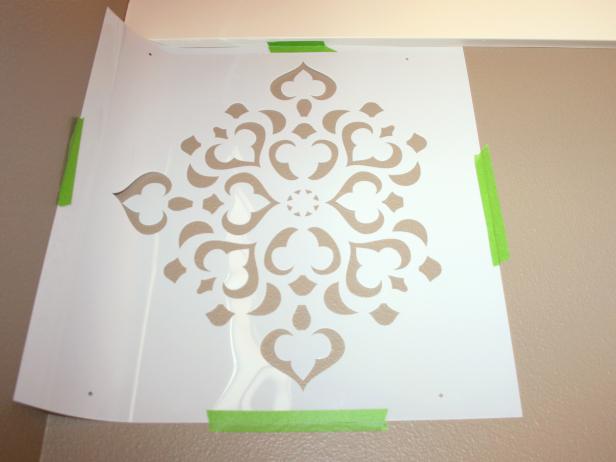 Stencil Attached to Wall With Green Painter's Tape