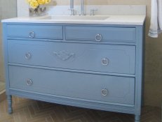 Blue Bathroom Vanity With White Countertop and Yellow Roses