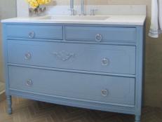 Blue Bathroom Vanity With White Countertop and Yellow Roses