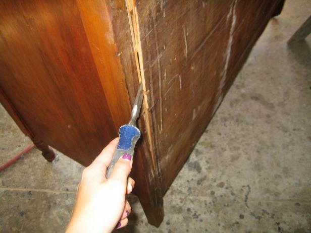 Using a Screwdriver to Pry Off Back of Cabinet