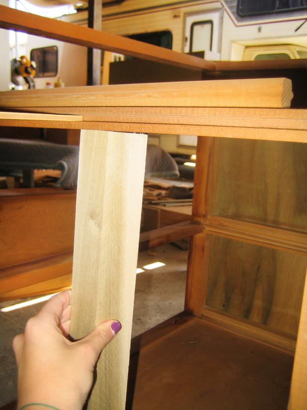 Using a saw, remove the original vertical support beam in the center back of the cabinet.
