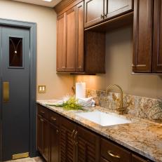 Laundry Room With Granite Countertops and Custom Cabinets