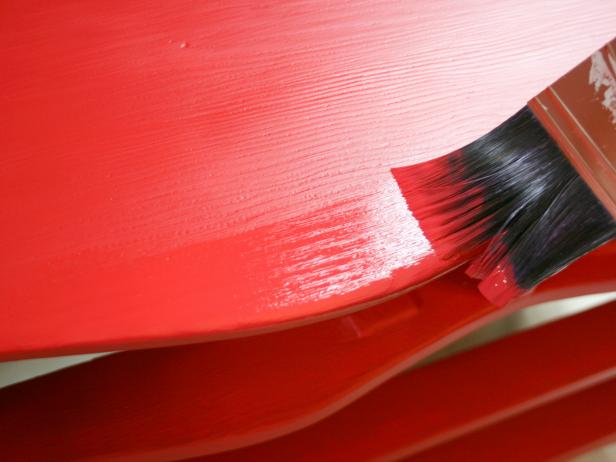 Applying Red Paint on Dresser