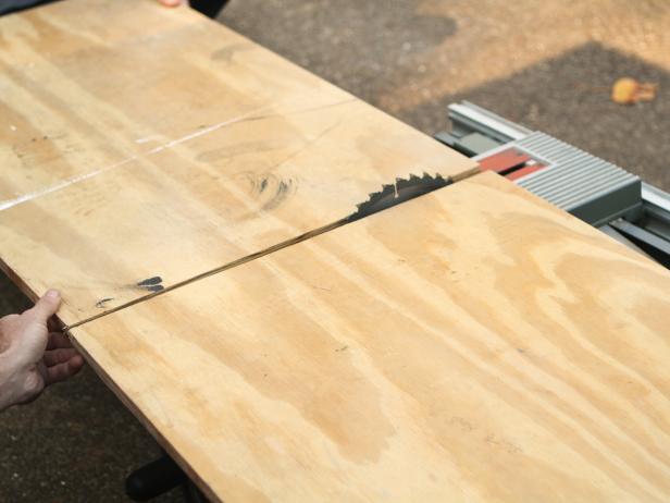 Referring to dimensions on notepad, measure, then mark plywood and trim pieces with pencil and spirit level. Use table saw to cut plywood to size.
