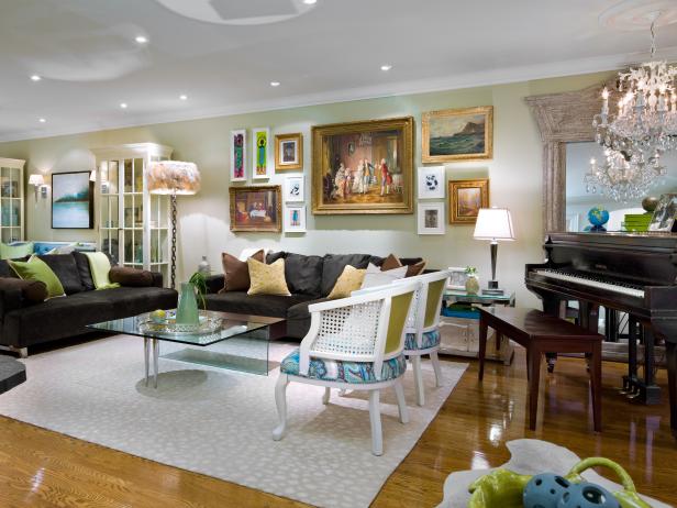 Family Room With Colorful Artwork, Glass Coffee Table and Black Sofas