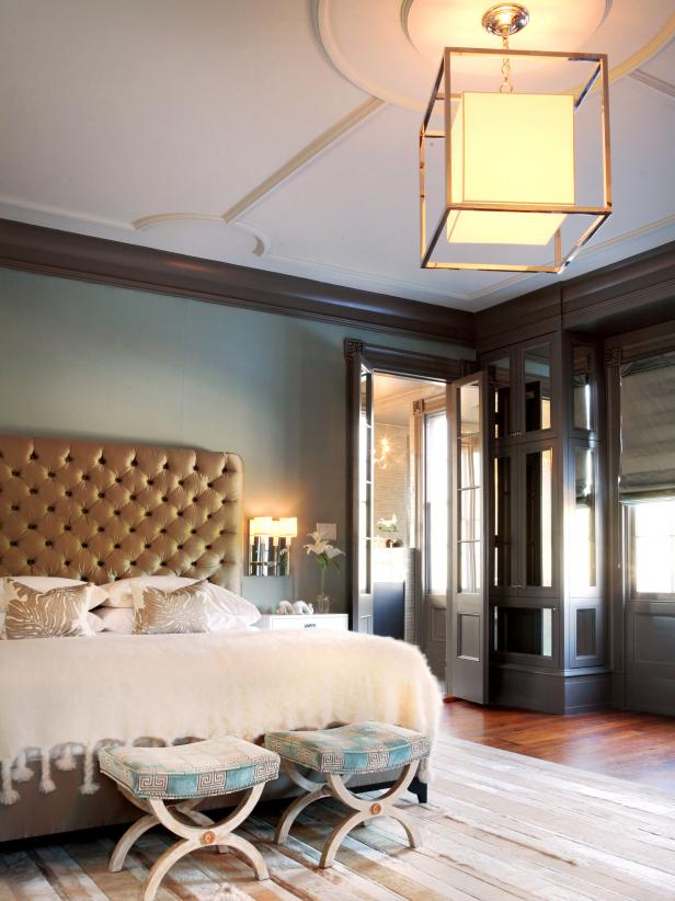 Green Bedroom With Gold Embellished Ceiling Light and Gold Headboard 