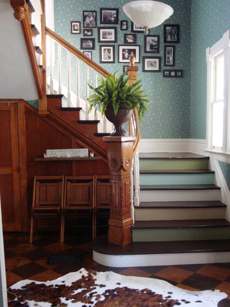 Different Colored Steps in Traditional Stairway With Gallery Wall