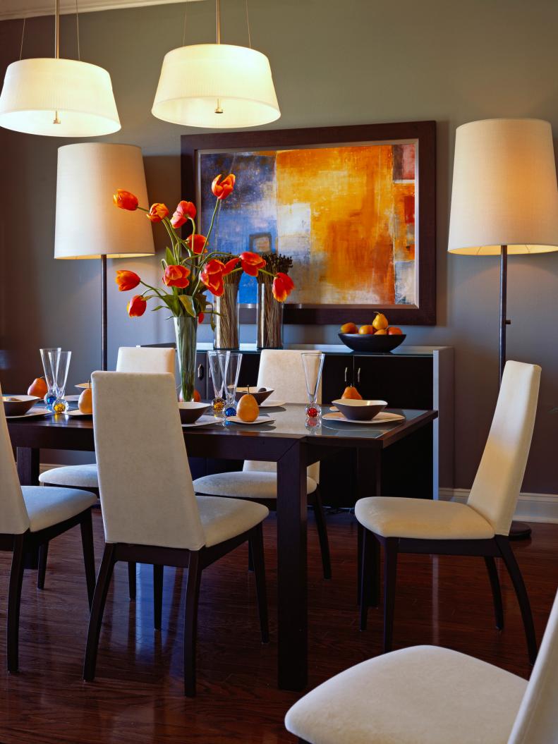 Gray Dining Room with White Pendants, Floor Lamps & Multicolored Art
